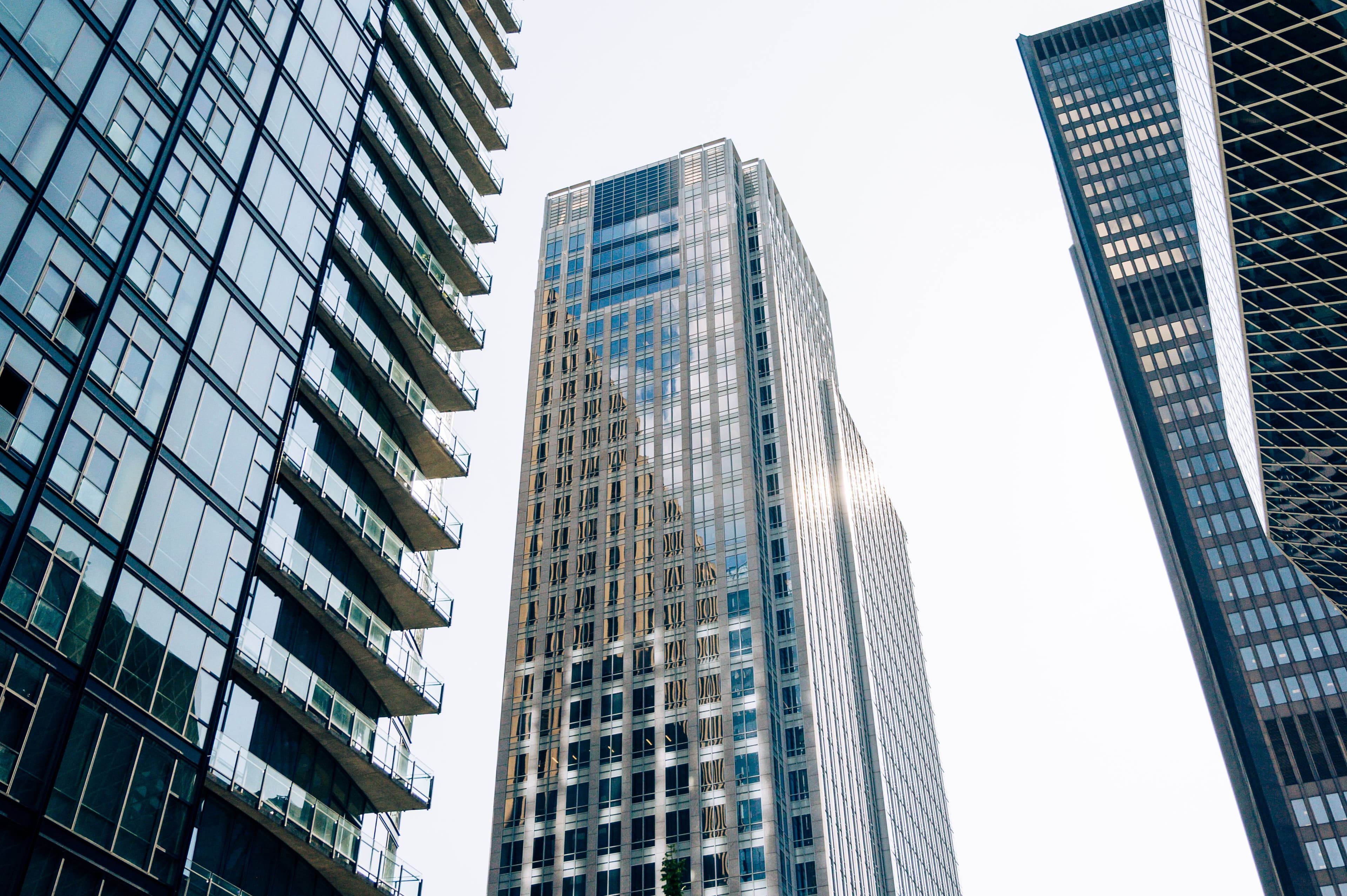 Glass office towers photographed from street level at dusk